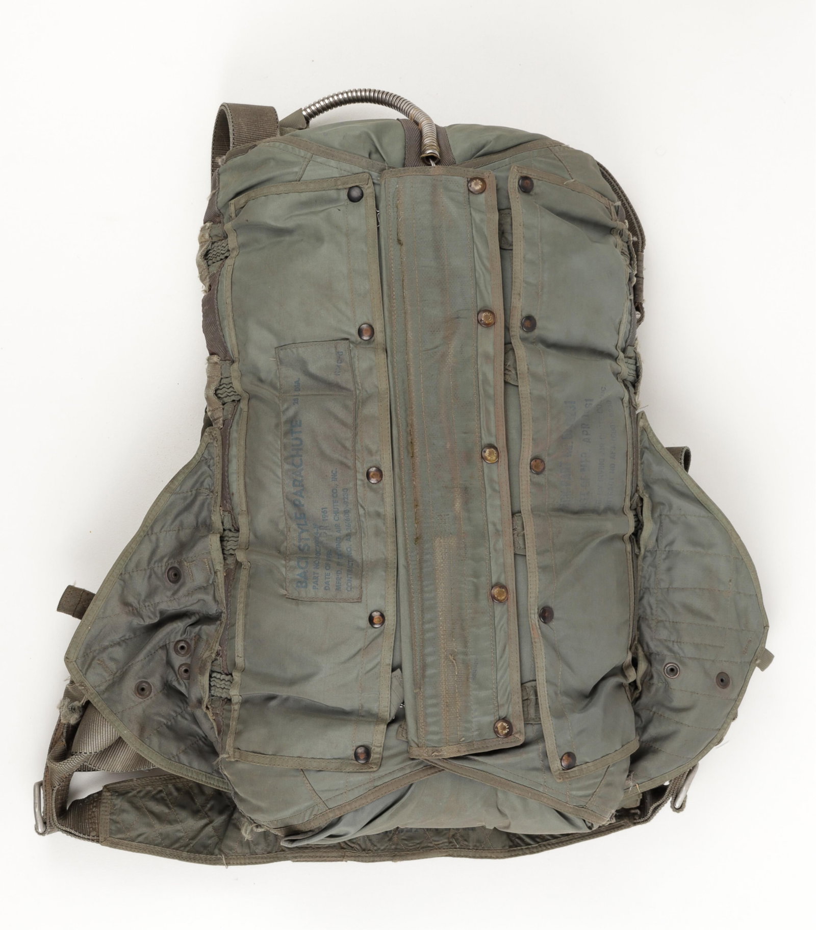VIETNAM WAR ERA MAIN PARACHUTE BAG AND HARNESS: Vietnam War era main parachute bag and harness, the main parachute used from the 50s until the late 70s for pilots to help ensure their safety. Most markings on the parachute are in black ink; the lab