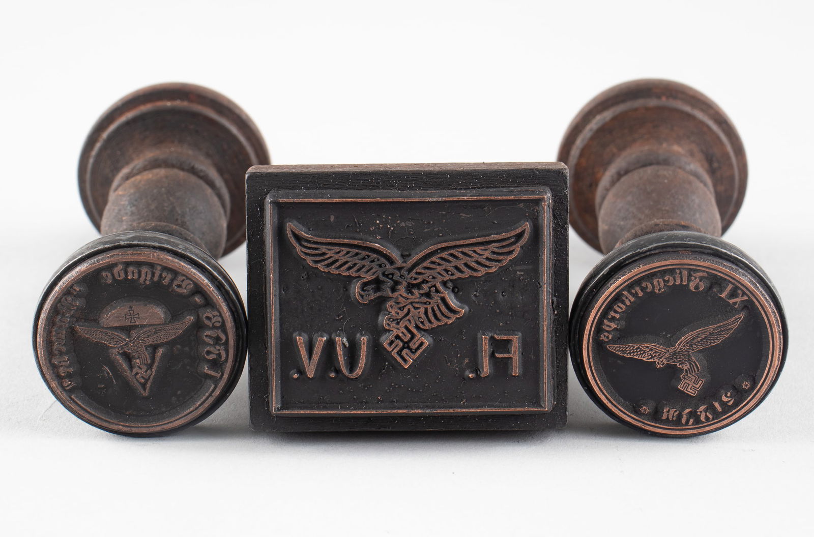3 WWII LUFTWAFFE HANDSTAMPS: Three WWII Luftwaffe handstamps, one reads '1 FJR Brigade Ramcke,' with Fallschirmjager insignia in the center, 'XI Fliegerkorps 21 FJR,' with a Luftwaffe eagle in the center, and one square stamp tha