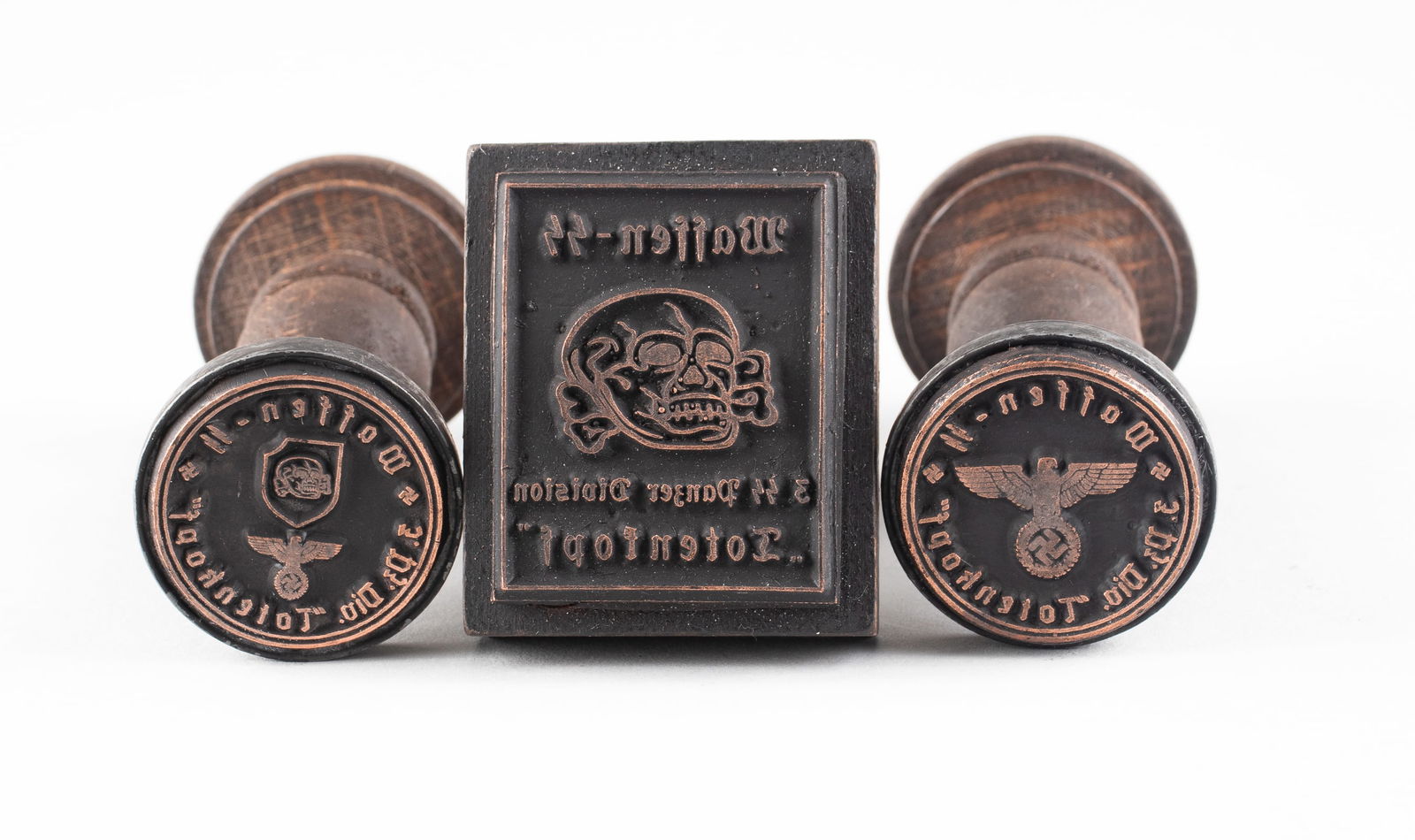 3 WAFFEN-SS 3RD PANZER DIVISION HANDSTAMPS: Three Waffen SS wooden handstamps, two read 'Waffen-SS 3. Pz. Div. Totenkopf,' one with a Reichsadler eagle in the center, one with eagle and Totenkopf skull in the center, and the square stamp reads