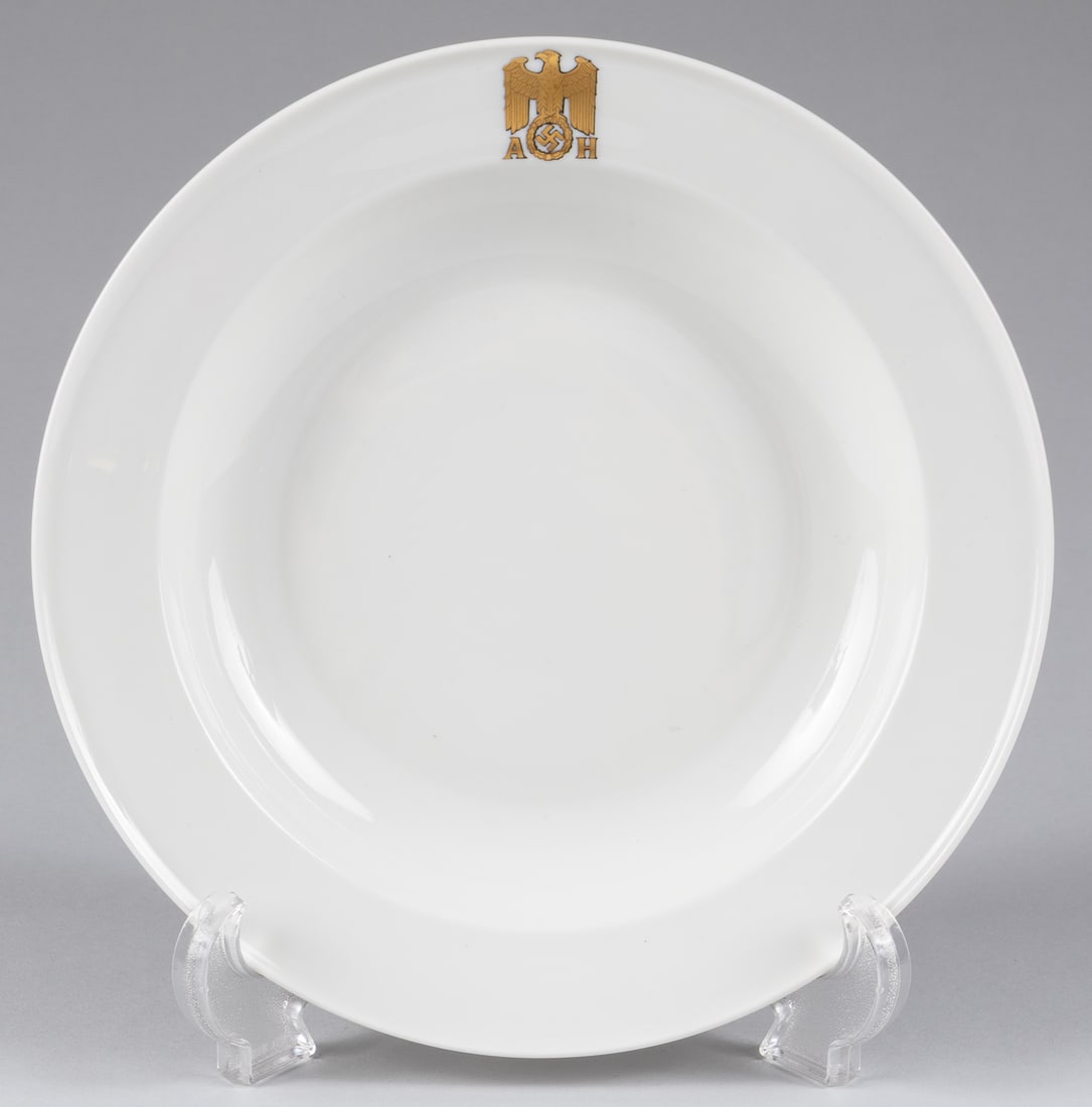 ADOLF HITLER ALLACH SOUP PLATE: WWII German Adolf Hitler soup plate made for Hitler by the SS Allach subcamp of Dachau. White china plate with a highly detailed gold eagle and swastika flanked by the initials 'A H' on the rim. The p
