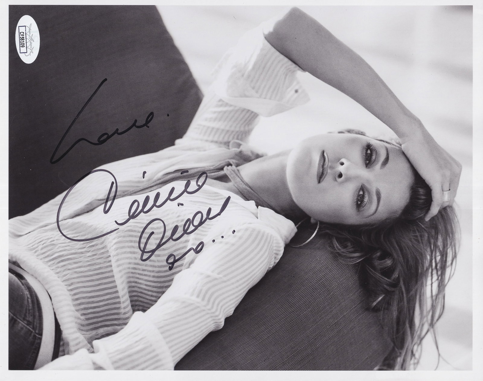 CELINE DION: Celine Dion (b. 1986), Canadian singer, known for her powerful, technically skilled vocals. Black-and-white photograph of Celine Dion, signed boldly in black ink, 'Love, Celine Dion xo...' 8 x 10