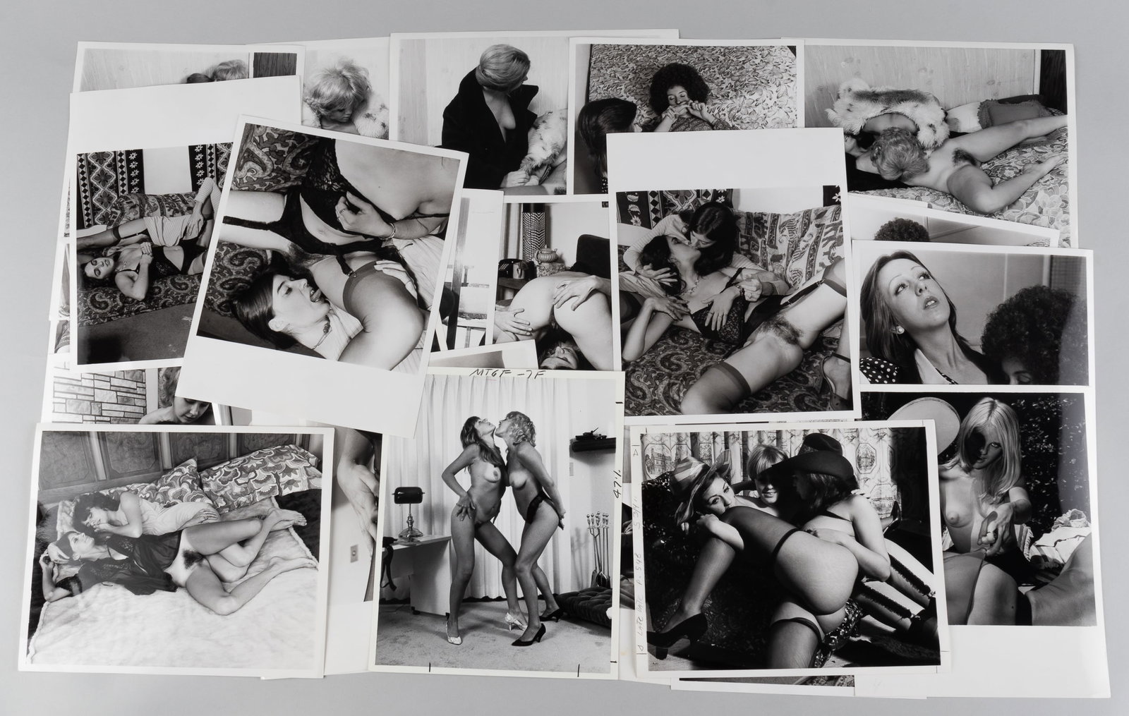 30 VINTAGE ADULT EROTIC LESBIAN PHOTOGRAPHS: Thirty vintage b/w adult lesbian erotic photographs, all from professional scenes, likely intended for magazine publishing, all with performer names on the reverse, three with crop marks and instructi