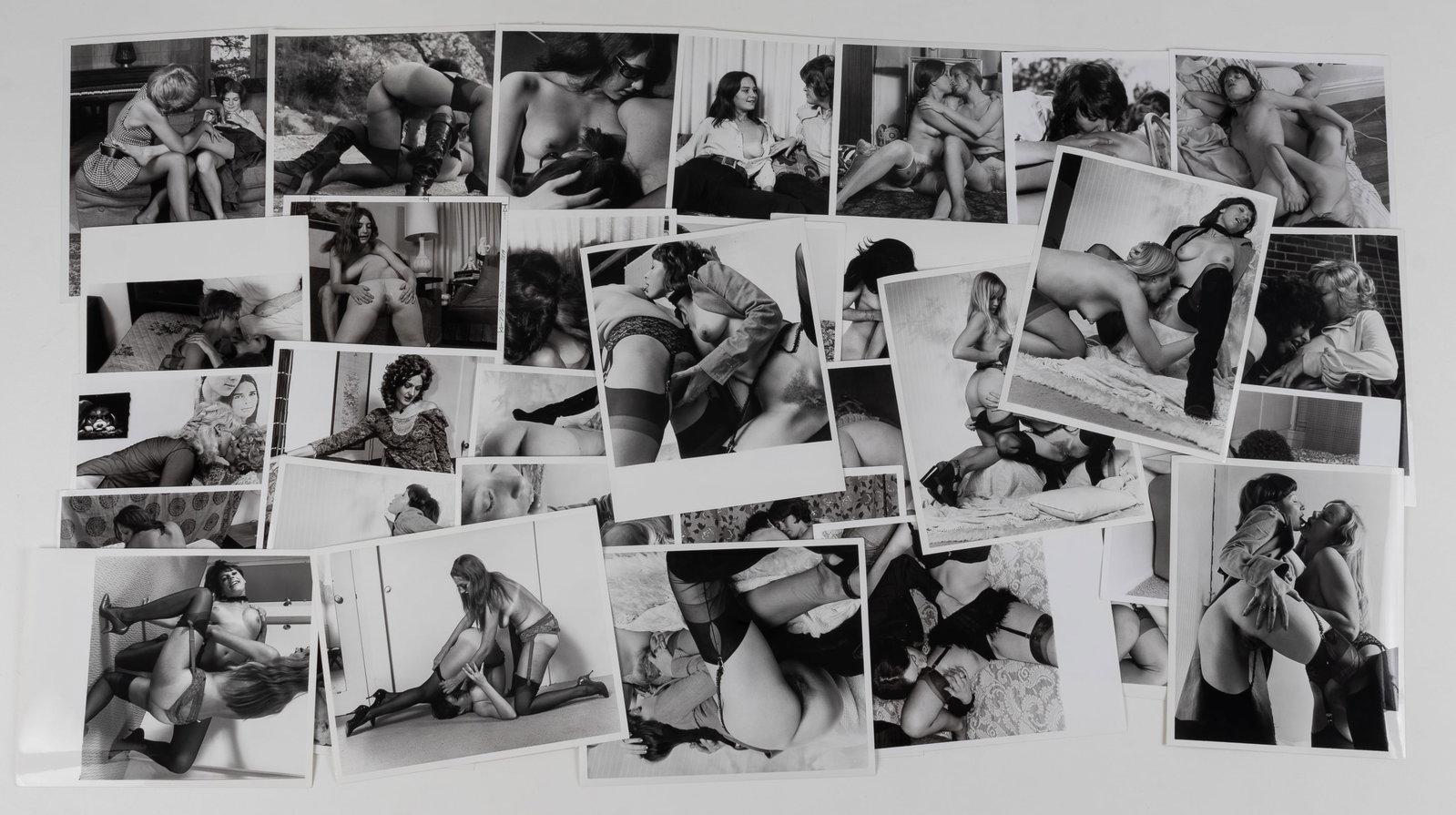 32 VINTAGE ADULT EROTIC LESBIAN PHOTOGRAPHS: Thirty-two vintage b/w adult lesbian erotic photographs, all from professional scenes, likely intended for magazine publishing, all with performer names on the reverse, one with crop marks and instruc
