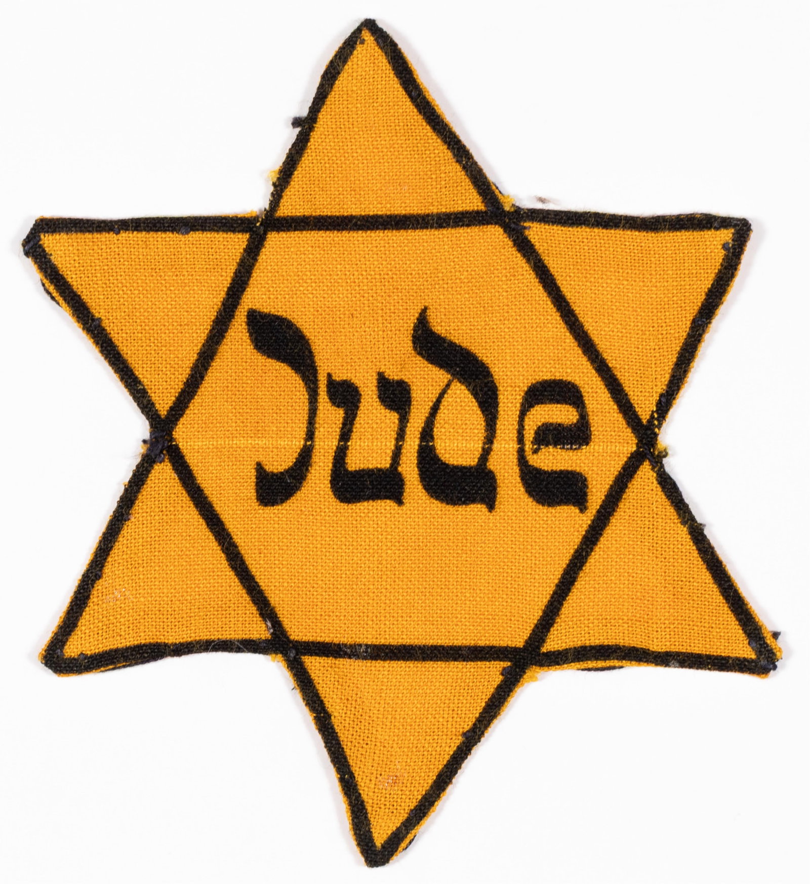 WORN JUDE STAR OF DAVID HOLOCAUST JUDAICA: Extremely scarce and historically significant Jude Star of David - Judenstern - worn and showing clear evidence of period use. Constructed from the correct yellow cotton fabric with appropriate wartim