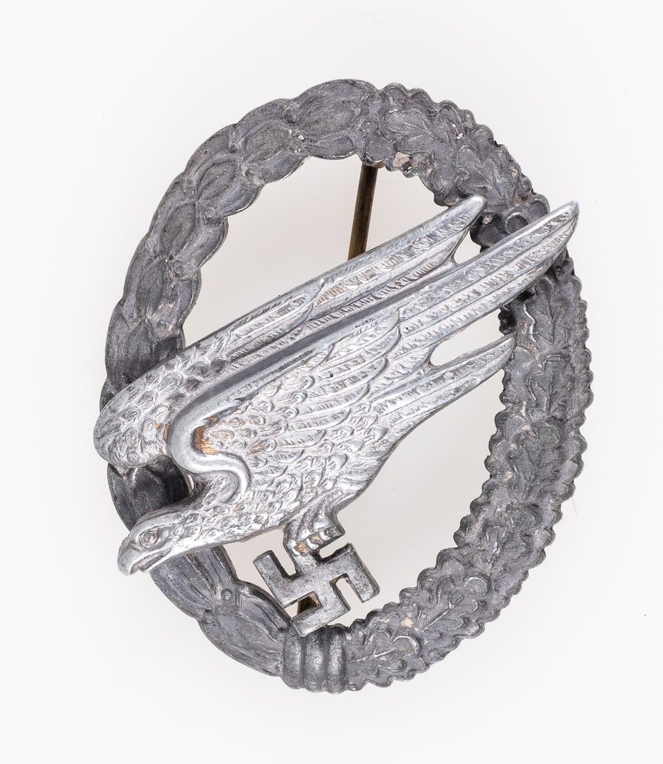 WWII LUFTWAFFE PARATROOPER BADGE BERG & NOLTE: WWII German Luftwaffe Paratrooper badge - Fallschirmjagerabzeichen der Luftwaffe- stamped on the reverse 'B&N L' for maker Berg & Nolte, Ludenschied. Zinc composition, missing gold wash on most of the