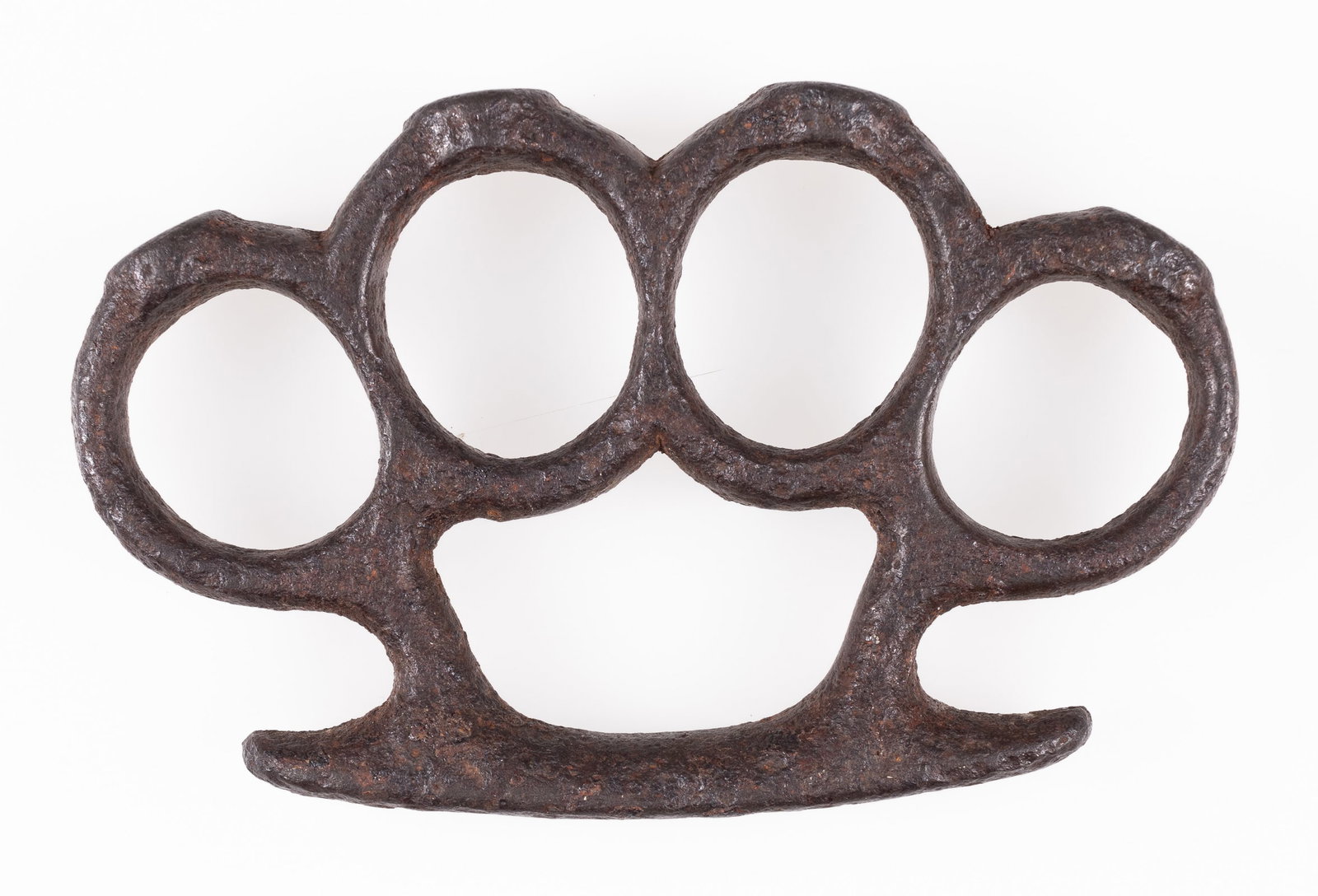 VINTAGE KNUCKLE DUSTER 'BRASS KNUCKLES': Vintage knuckle duster, 'Brass Knuckles,' unmarked, solid steel or iron construction, signs of wear, and previously heavily oxidized; most oxidation has been cleaned off. Sections chipped or shaved