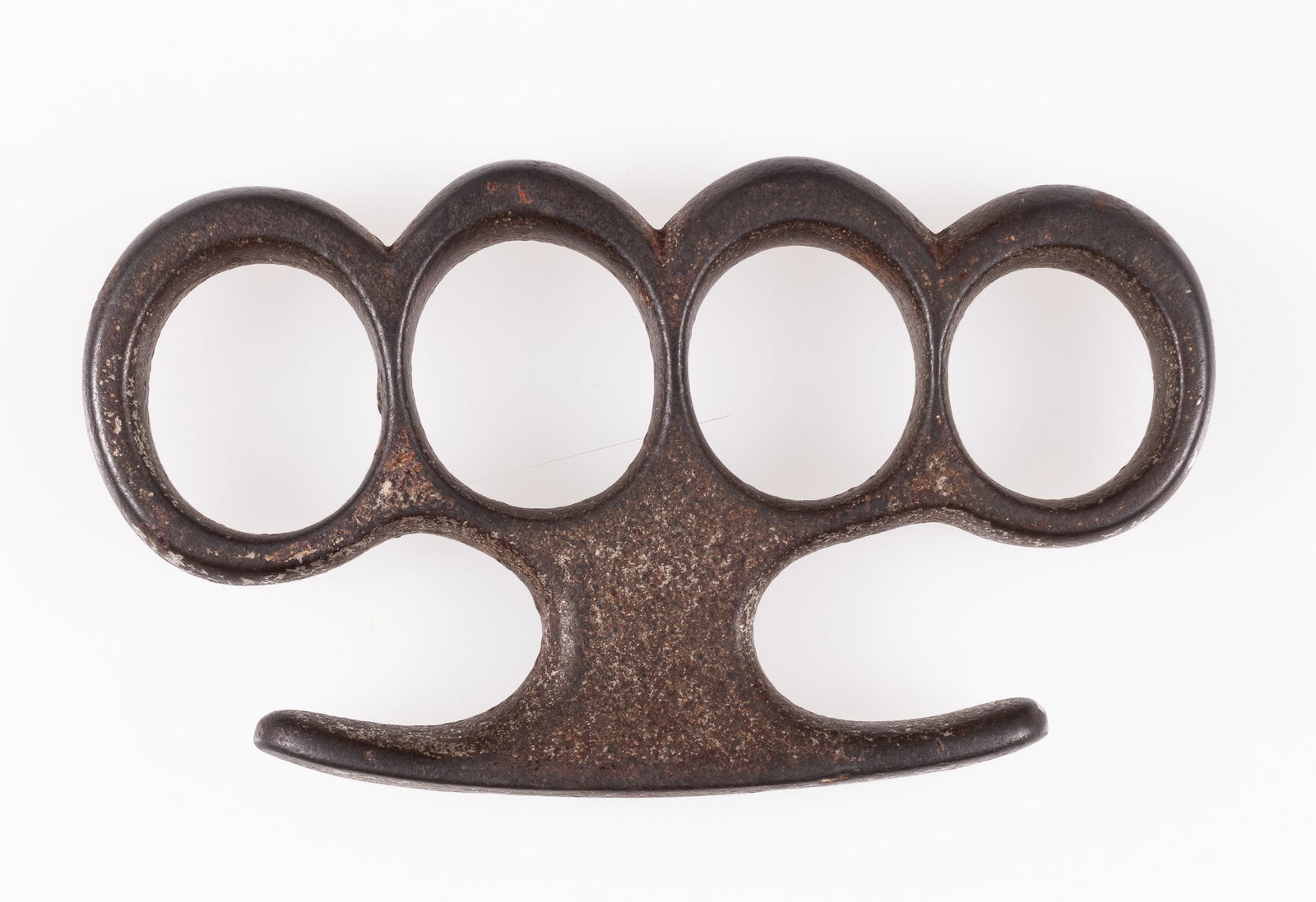 VINTAGE KNUCKLE DUSTER 'BRASS KNUCKLES': Vintage knuckle duster, 'Brass Knuckles,' unmarked, solid steel or iron construction, signs of wear, and previously heavily oxidized; most oxidation has been cleaned off. Pitting throughout. 4.25 x