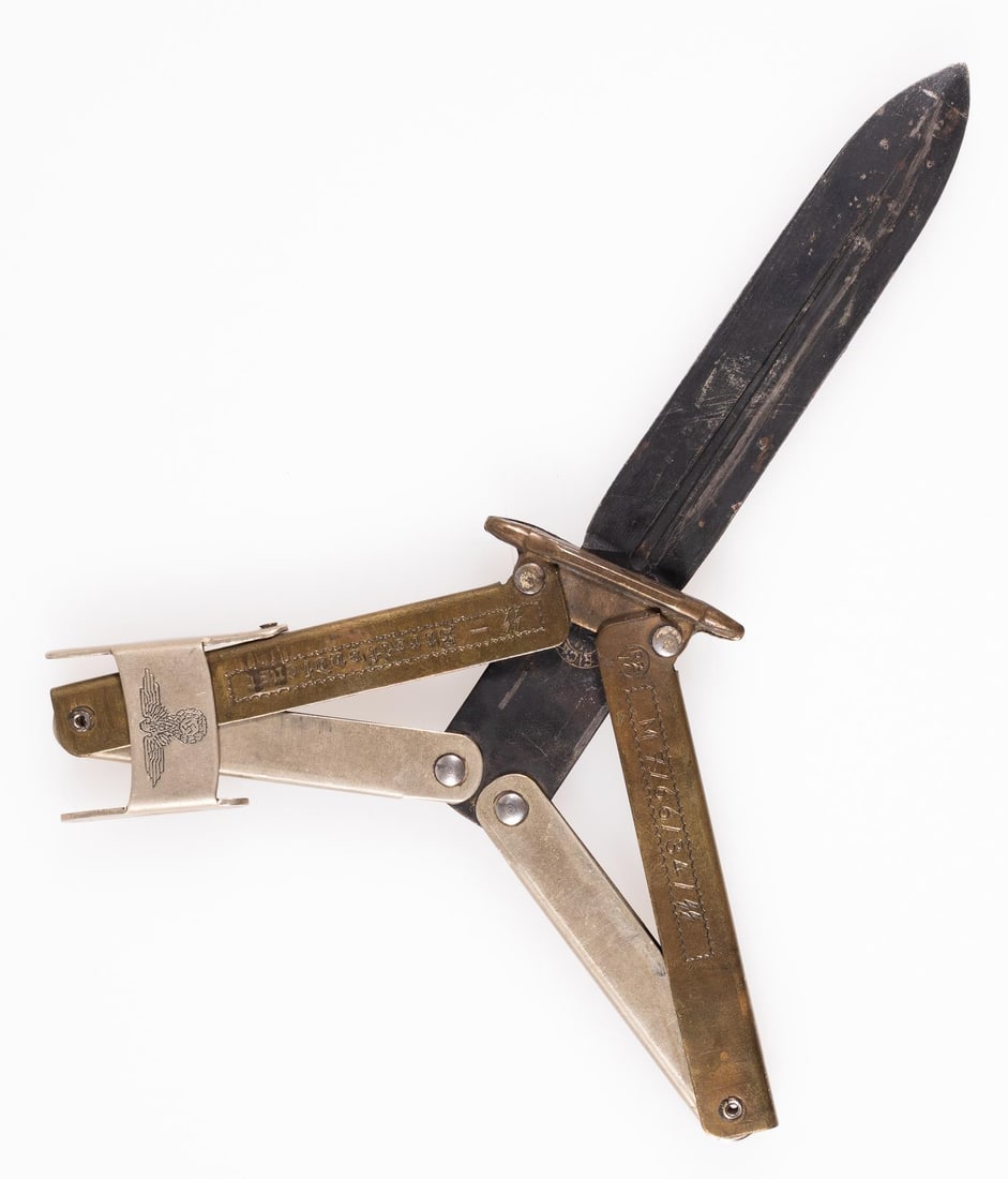 FANTASY GERMAN SS STREIFENDIENST BUTTERFLY KNIFE: Fantasy German SS-Streifendienst butterfly knife, folding handle, marked 'RZM M7/66/34/SS SS-Streifendienst.' Closing clip with an SS eagle insignia on the front. Eickhorn maker's mark on the blade