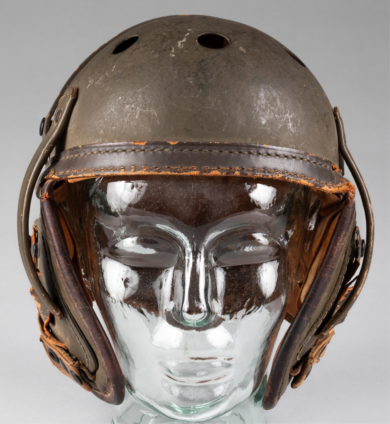 WWII U.S. ARMY M38 TANKERS HELMET: WWII American M-1938 tanker helmet. Leather liner present; no chin strap; padded liner damged in places. Marked on the back of the liner: 'Sears Saddlery Co. Davenport, Iowa,' size 7. Wear to the inne