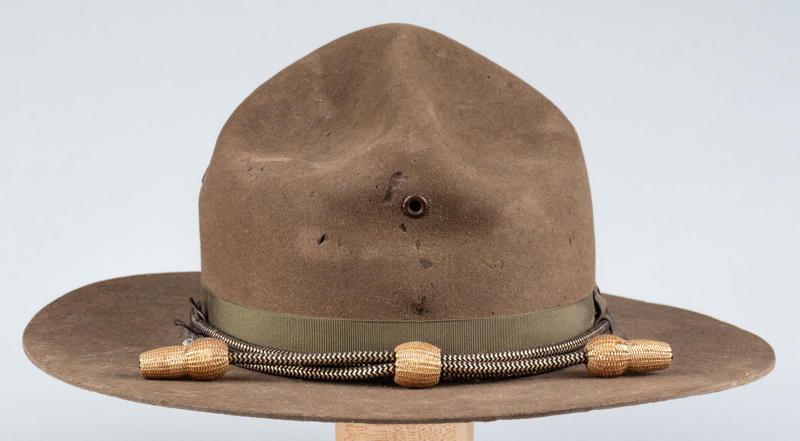 ORIGINAL WWI U.S. ARMY CAMPAIGN HAT M1911 W/ OFFICER'S CORD: Original WWI M1911 U.S. Army officer's campaign hat, silk band in good condition, with a gold and black cord and gold acorns for commissioned officers. The brim has no stitching, identifying it as the