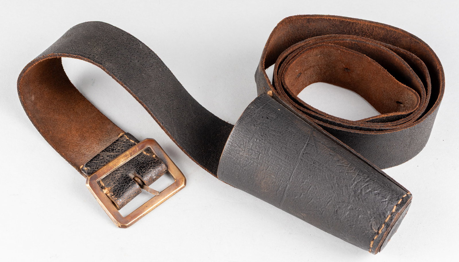 FLAG BEARER LEATHER BELT: Flag bearer leather belt, simple brass buckle, and simple leather flag holster in the front, unmarked. The belt portion is 48 inches long. Fine example with minor wear throughout. From the personal co