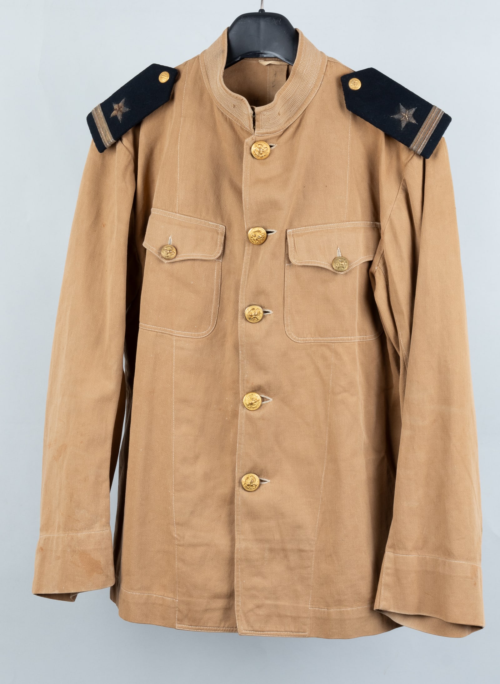 WWI US NAVY OFFICERS KHAKI TUNIC: WWI U.S. Navy Officers khaki tunic, with a pair of bullion Line Officer shoulder boards, and fitted with the WWI eagle grasping anchor tunic button. Stamped on the bottom front inside of the tunic rea