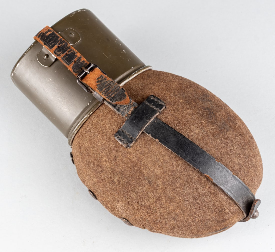 WWII GERMAN WATER CANTEEN: WWII German Wehrmacht Medic's 1L field aluminum water canteen with felt wrap in very good condition, leather strapping, with a Bundeswehr-era aluminum cup.