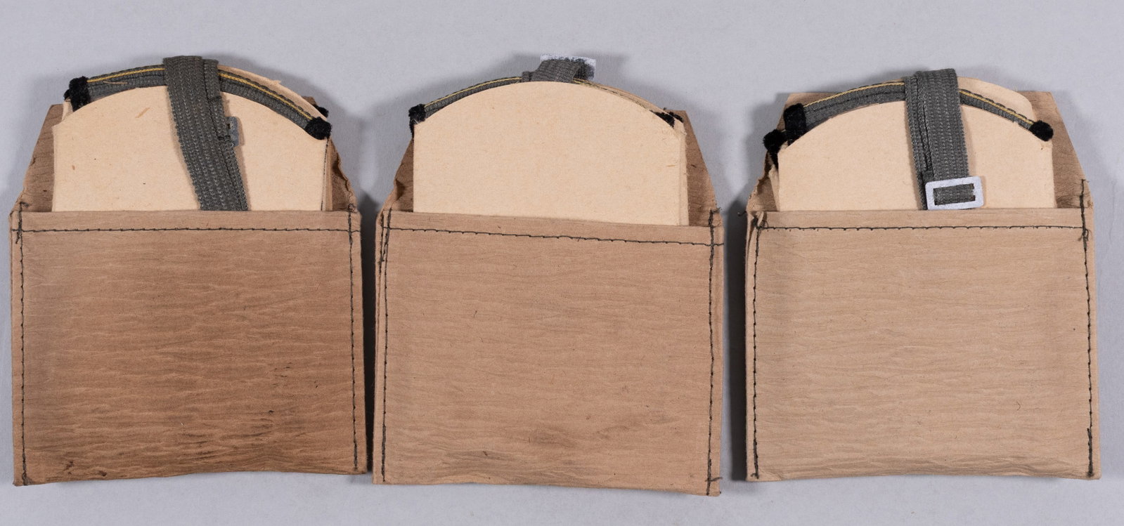 GERMAN AFRIKA KORPS SAND GOGGLES 3 PAIRS: Three pairs of German Afrika Korps sand goggles, used by German soldiers to help keep sand out of their eyes. All pairs have clear, foldable lenses, grey straps, and black velvet lining for comfort.