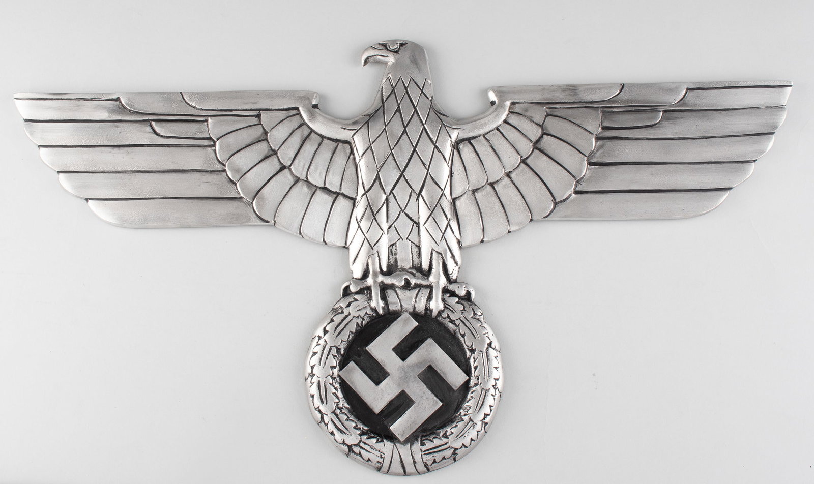 GERMAN RAILROAD EAGLE DISPLAY: German railroad eagle, measuring approx. 27.5 x 15 inches. The front shows a spread-winged political German eagle clutching a swastika; the reverse shows four mounting holes. These eagles were suppose