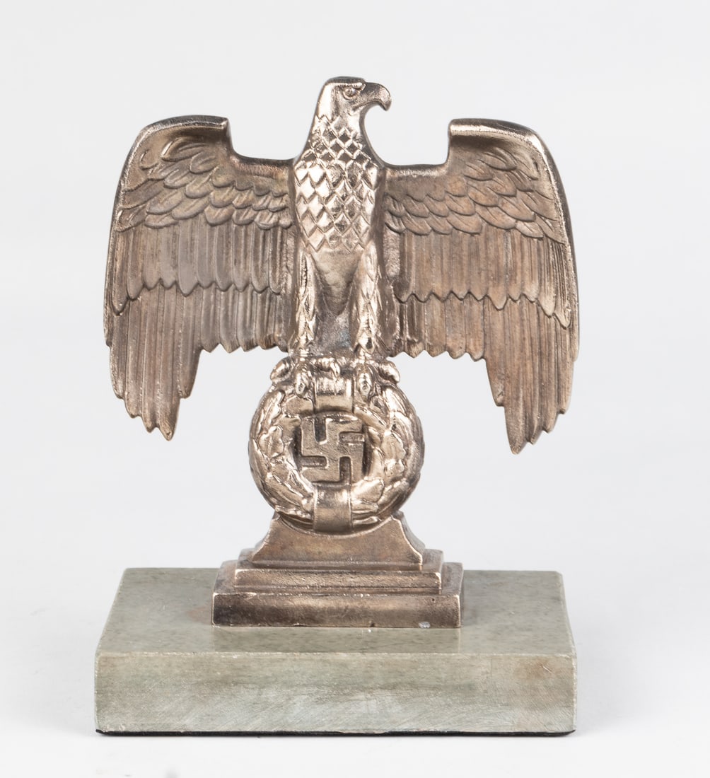 GERMAN NAZI EAGLE DESK STATUE: German Nazi Reichsadler desk diplay statue. A Reichsadler eagle holding a wreath with a swastika in the center, mounted on a gray granite stand. The reverse side of the wreath also features a