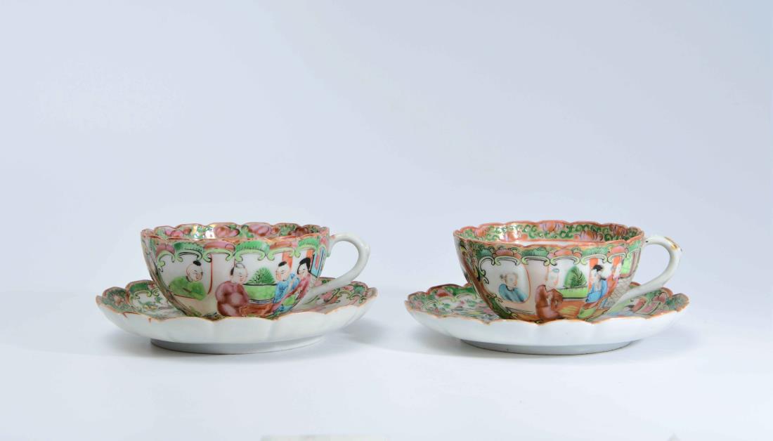 A PAIR OF CHINESE EXPORT FAMILLE ROSE TEA CUPS: A pair of Chinese Export famille fose tea cups and saucers with figures and flowers decorations. Dimension: Each cup H 5 cm, Rim Diam 9.3 cm. Each saucer Diam 14 cm.All measurements are approximate. T
