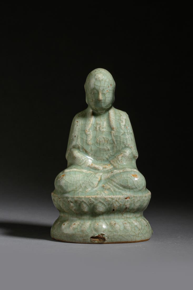 A CELADON GLAZED STATUE OF SAKYAMUNI BUDDHA: A celadon glazed statue of sakyamuni buddha with crackle pattern. Closed eyed sakyamuni buddha seating in meditation on lotus throne. PROVENANCE: Formerly in the Collection of a retired Japanese Ameri