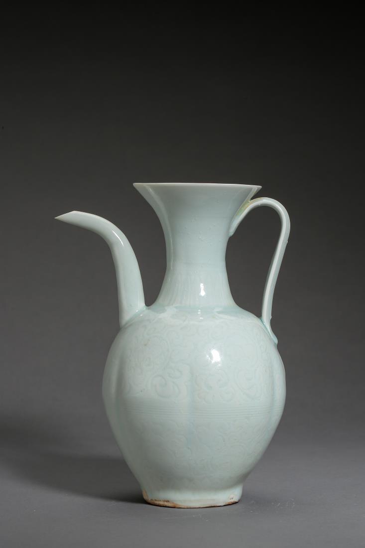A SONG HUTIAN WARE PORCELAIN EWER: A song hutian ware porcelain ewer with white-celadon glaze. Globular body covered all in floral pattern, flanked with curved spout and looped handle. PROVENANCE: Property from a Private Collection, Ph