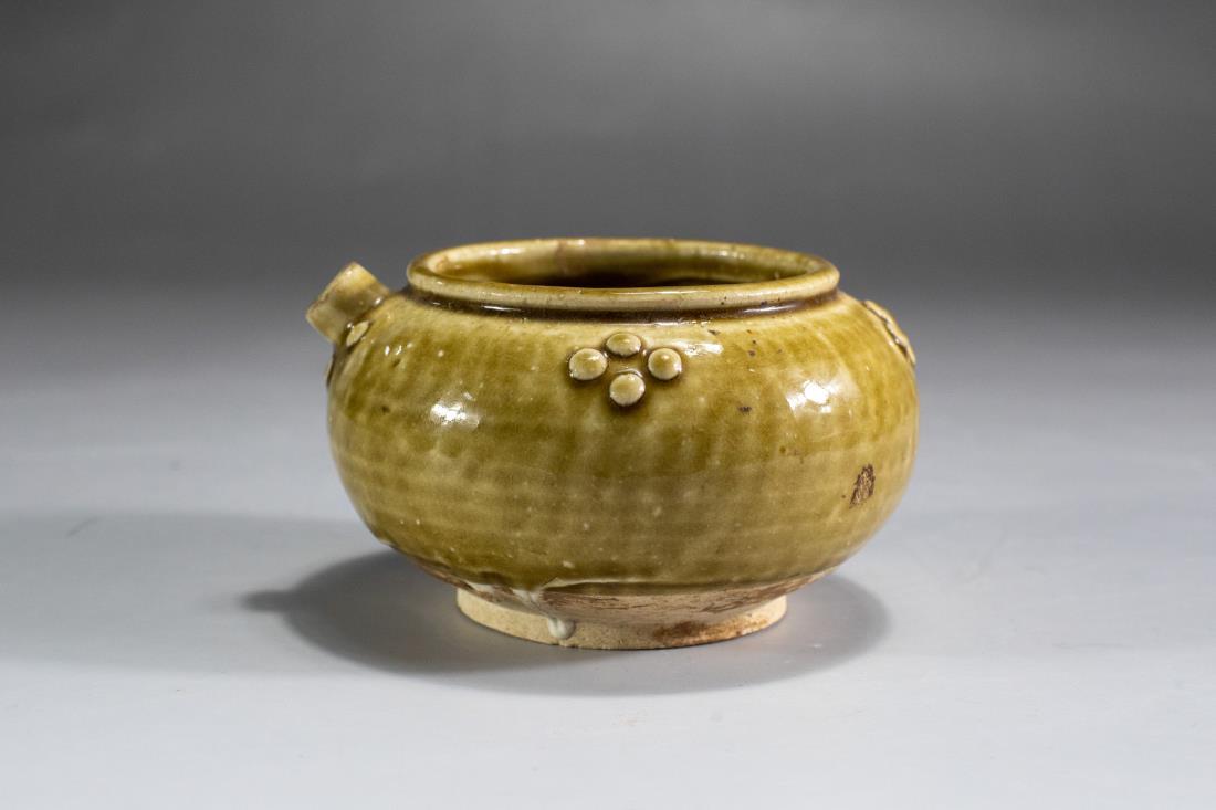A TANG XING WARE YELLOW GLAZED WATER POT: A tang dynasty period, xing kiln ware, water pot with round body, yellow glaze on the exterior stops around the foot. The base left un-glazed.PROVENANCE: Property from a Private Collection, Philadelph