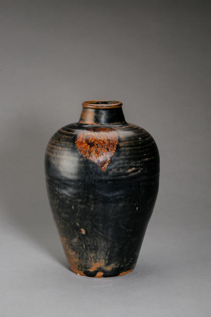 A SONG JIZHOU WARE MEIPING VASE WITH LEAF: A song dynasty meiping vase with black glaze. Chinese jizhou ware with simple globular oval shape. The exterior characterized with pre-rotted leafs mounted underglazed on the shoulder. PROVENANCE: Pro