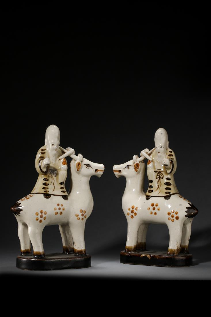 PAIR OF CIZHOU FIGURINES OF DEER & SHOU DEITY: Pair of cizhou figurines of deer and 'shou' deity, Chinese Ming Dynasty Period, in form of two standing traditional longevity 'shou' deity on top of deer with flower spot. Dimension: H 25 cm, W 17 cm.