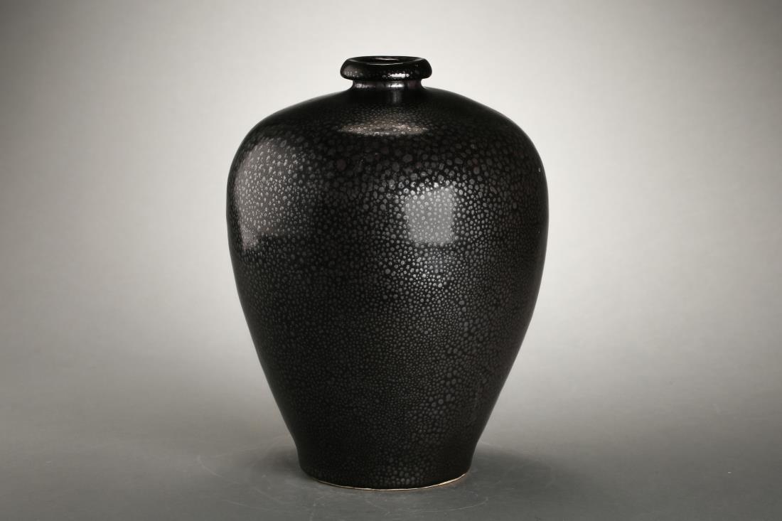 A YUAN CIZHOU WARE BLACK-GLAZED 'OIL' VASE: A yuan cizhou ware black-glazed 'oil' vase, Chinese Yuan Dynasty Period, depicted with oil spots in black glazed background, the base is left un-glazed. Dimension: H 24.8 cm, Diam 19.5 cm. All measure