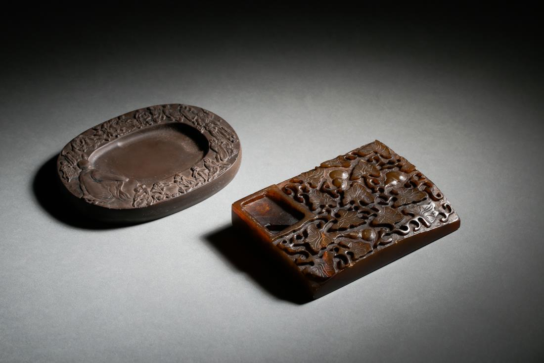 SET OF SHOUSHAN AND STONE CARVING INKSTONES: Set of shoushan and stone carving inkstones, Chinese Qing Dynasty Period. One is in arhat motif and one is relief carved with lotus pattern. Arhat Inkstone: H 8.4 cm, W 11.5 cm. Lotus Inkstone: H 8.4