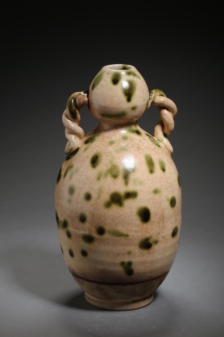 A CIZHOU WARE BIZARRE PORCELAIN GOURD VASE: A cizhou ware bizarre porcelain gourd vase with green dots. Dimension: H 26 cm, Diam 14.5 cm. All measurements are approximate.