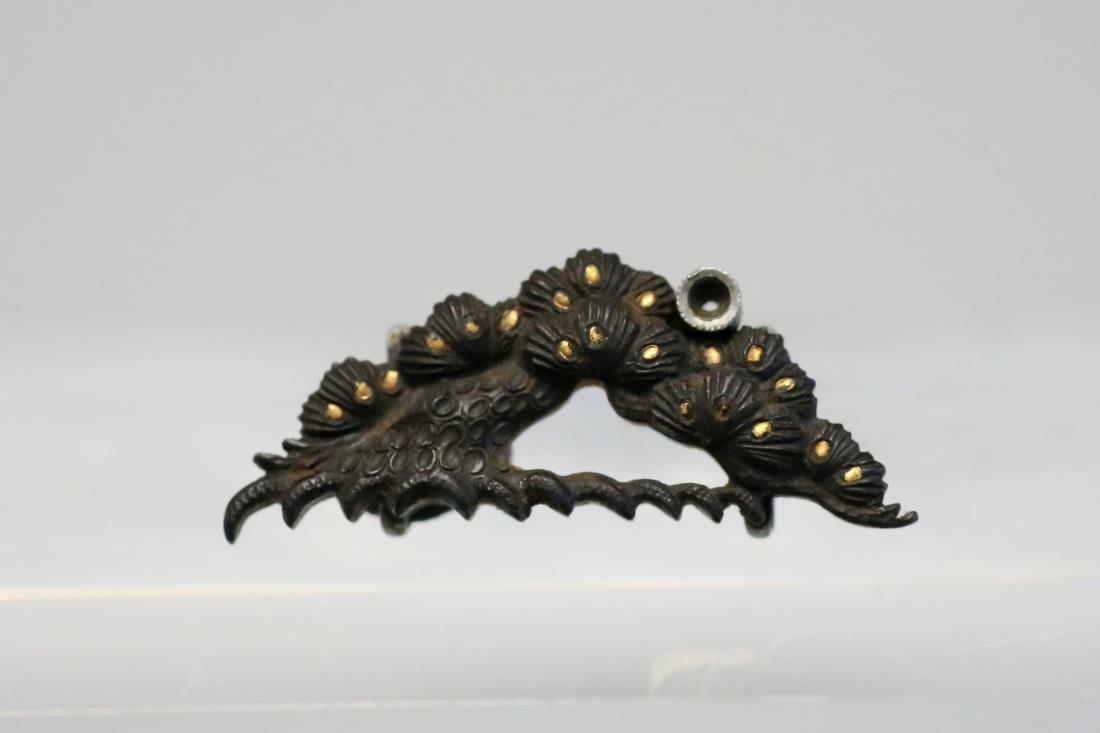 A GOLD AND SILVER INLAID 'PINE TREE' IRON BUCKLE: A gold and silver inlaid 'pine tree' iron buckle décor Dimensions: H 3.4 cm, W 6.5 cm, D 1.4 cm. Weight: 11.3 g. All measurements are approximate. Provenance: property from a private collector in