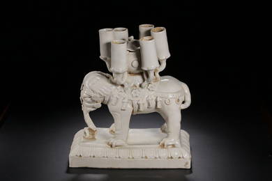 A WHITE GLAZED ELEPHANT PORCELAIN CANDLESTICK