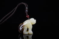 A CHINESE QING SEED JADE CARVING OF BEAST PENDANT