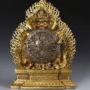 A GILT BRONZE FIGURE AND SILVER MANDALA