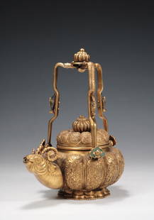A GILT BRONZE 'RAM' LOOP-HANDLED TEAPOT: A gilt bronze 'ram' loop-handled teapot. There is a six-character 'Bao Zhu Jia Cang Qing Wan' on the bottom. Dimensions: H 21 cm. Weight 746 g. All measurements are approximate.
