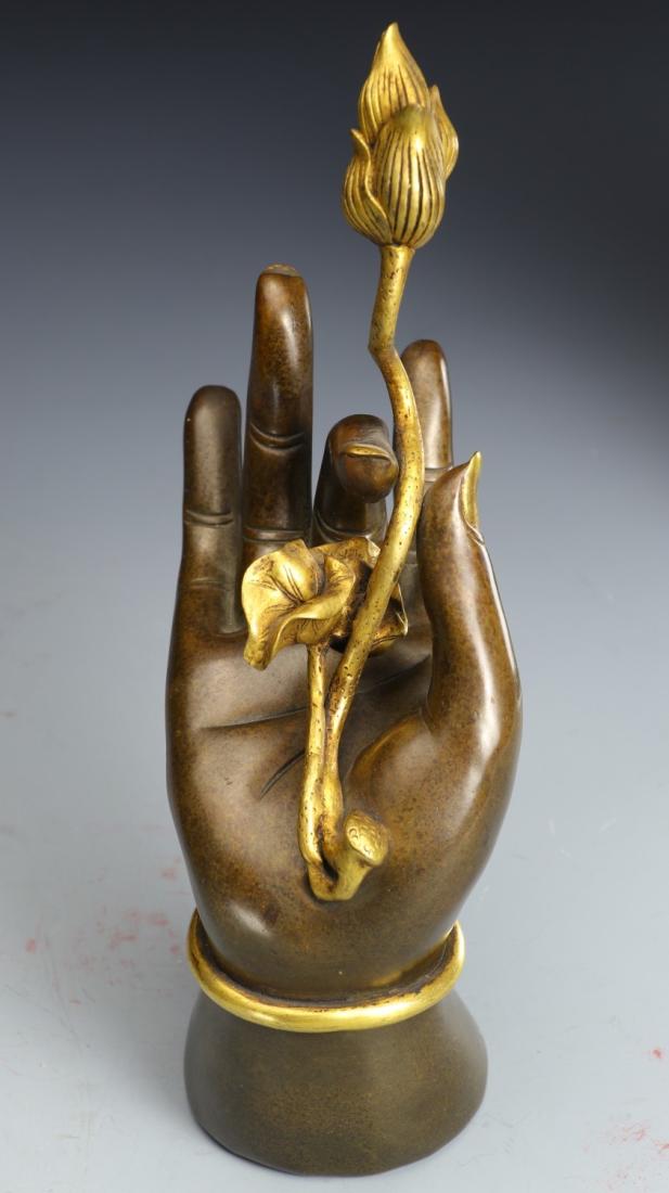 A GILT BRONZE BUDDHA HAND HOLDING LOTUS FLOWER (1 of 9)