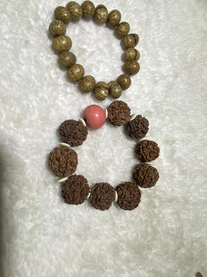 SET OF RUDRAKSHA BRACELETS: Set of rudraksha bracelets. Dimensions: The larger one: Bead Diam 2.0 cm. All measurements are approximate.