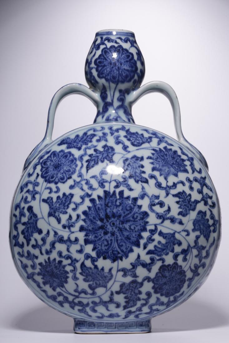 QING, BLUE AND WHITE MOON FLASKS VASE: Qing, Blue and white interlocking flowers moon flasks vase. Dimensions: H 28.5 cm, Diam 20.5 cm. All measurements are approximate.