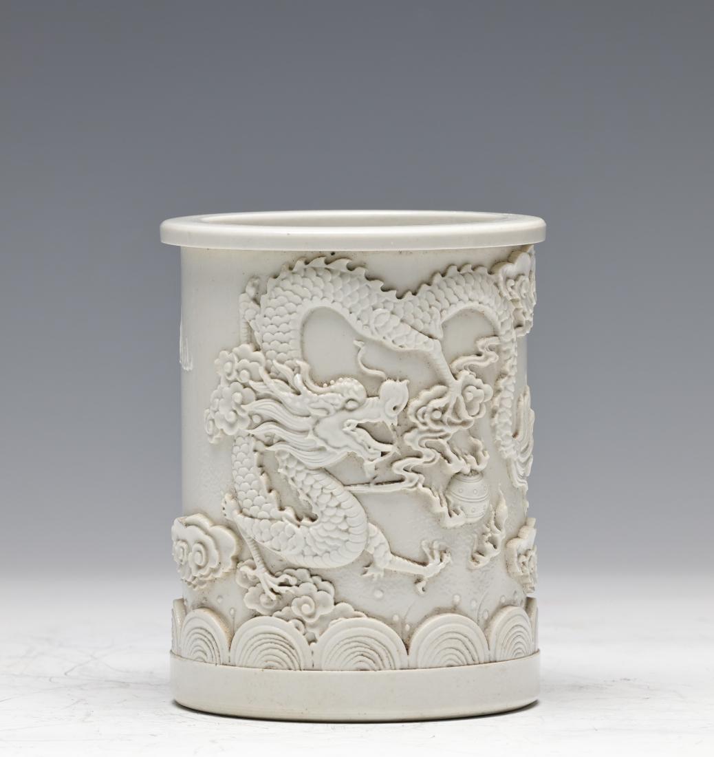 QING, WHITE GLAZED LOW RELIEF 'DRAGON' BRUSH POT (1 of 4)