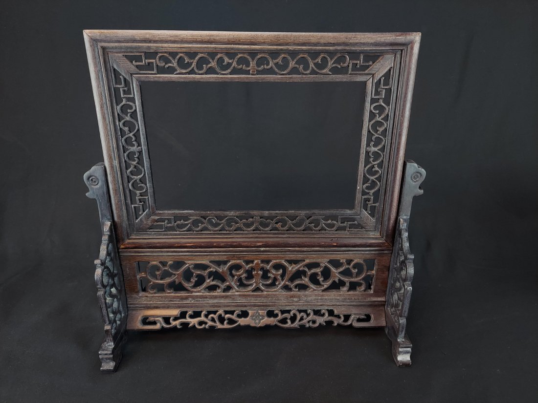 CHINESE WOOD FRAME AND STAND: CHINESE WOOD FRAME AND STAND DECORATED WITH VARIOUS BORDERS AND GEOMETRIC PATTERNS. MEASURES 13 1/2" HIGH X 13" WIDE X 5" DEEP. THE FRAME OPENING MEASURES 8 1/4" WIDE X 5" HIGH
