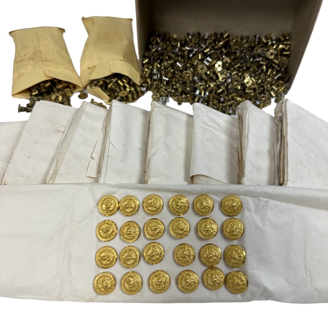 Small Gold Military Button & Screw Back Tube Lot: Large lot of vintage small gold plated military buttons with screw back tubes. Several hundred buttons on cards in paper wrapped packs of 24.