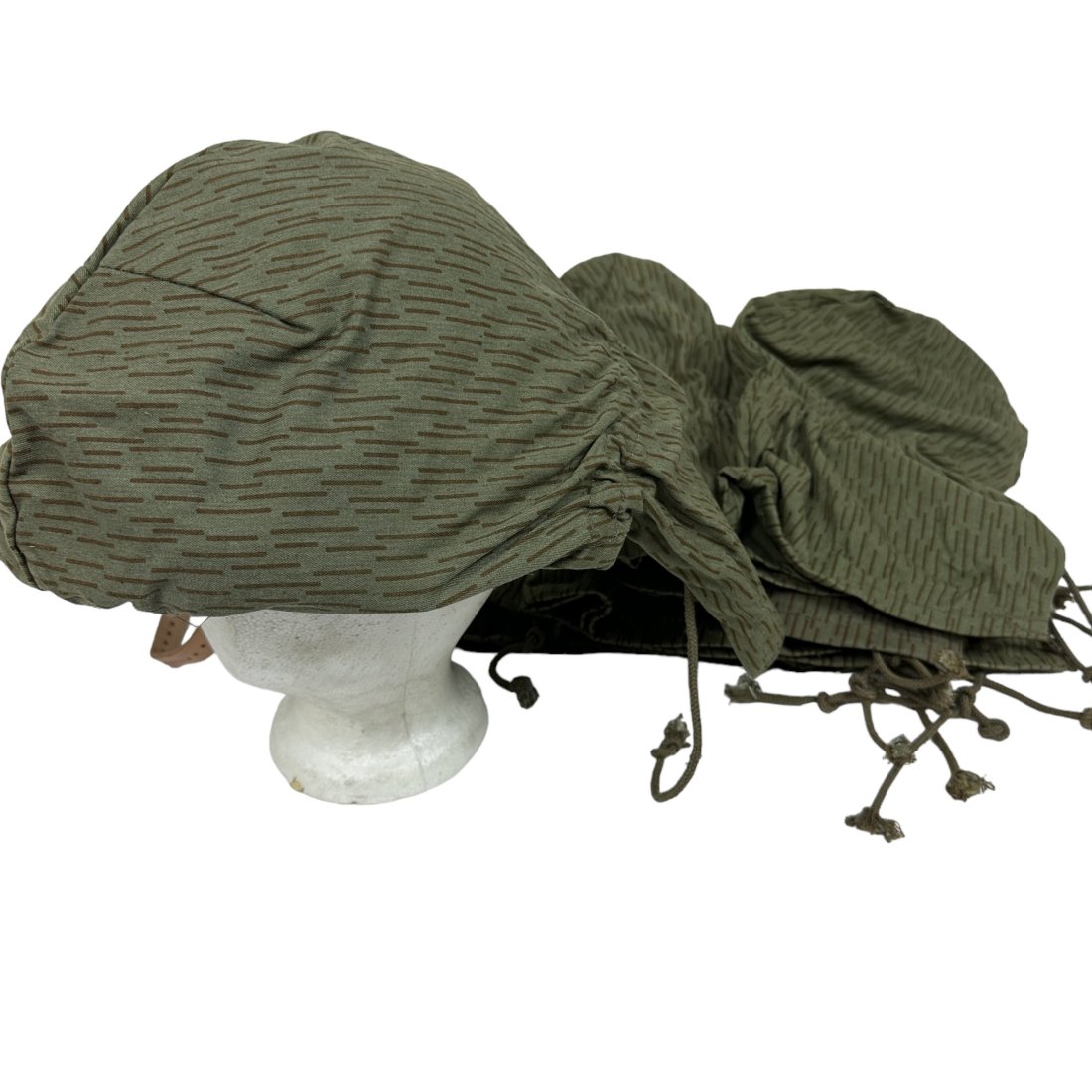 10 Surplus East German Helmet Cover Lot - helmet not included sizes may vary: Lot of 10 vintage surplus East German helmet covers. Helmet not included. Sizes may vary.