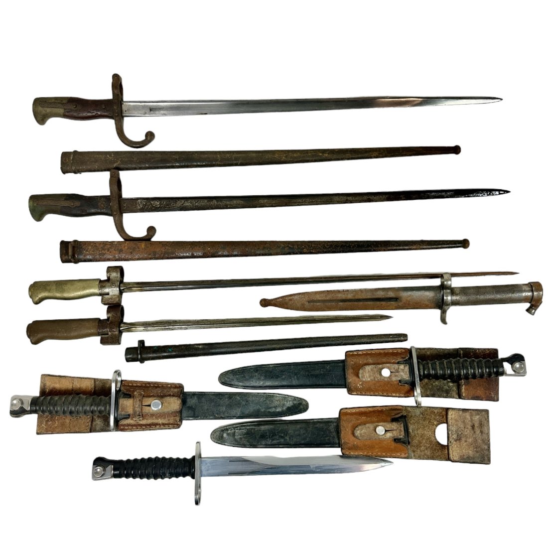 8 Foreign Bayonet Lot Antique French Swiss Swedish: Lot of 8 antique and vintage foreign bayonets. Several antique French. Vintage Swiss and Swedish. All with scabbards. Some rust throughout.