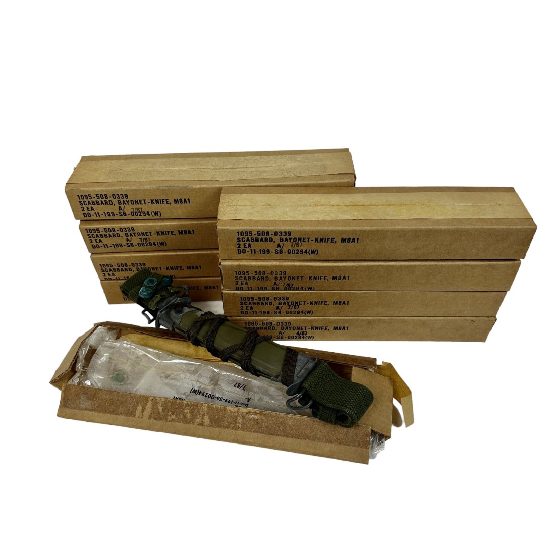 18 Surplus 1967 US M8A1 Bayonet Scabbard Lot: Lot of 18 surplus US M8A1 bayonet scabbards. 9 boxes of 2, 8 of the boxes are sealed. 1967 dates on boxes.