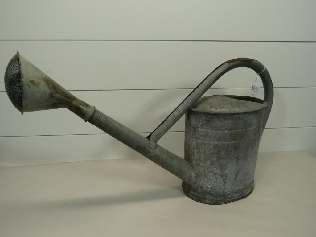 Galvanized Batwing Watering Can: Looks to be 2 1/2 gal. 29" long 17" total height. No visible holes.