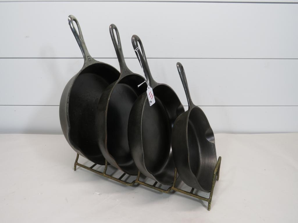 Griswold Erie Large Logo #5-7-8-9 Skillets with Stand: Lot includes four skillets and the stand. There is no wobble or spin to any of the skillets. Skillets #5, 7, and 8 are all very clean. There are a couple spots of very minor pitting in skillet #9.