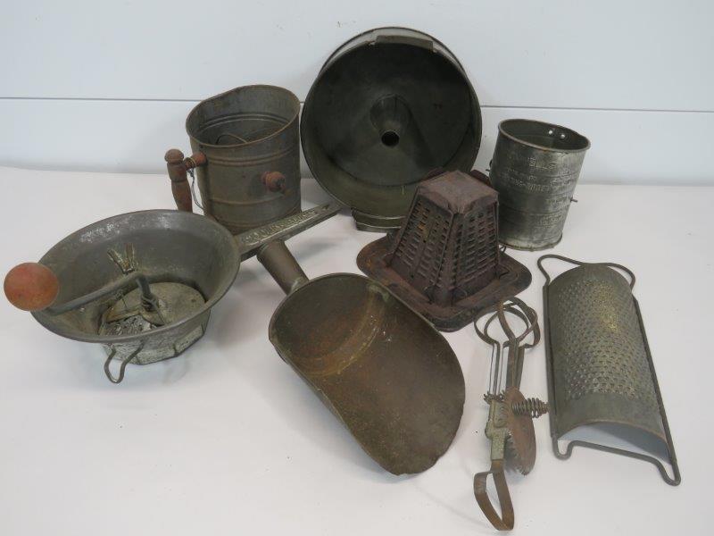 Primitive Lot of Kitchen Tinware: Lot includes eight tin kitchen utensils including sifters, egg beaters, graters, and scoop.