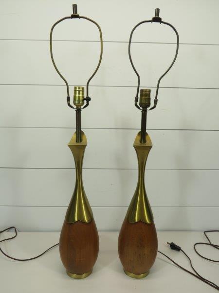 Pair of Mid Century Wood and Brass Lamps: Original harps and japanned brass finials. Wood and brass bases. Some finish damage to the bottom brass rims. In working order, but the plugs are older. Lamp base: 18 3/4" Height to finial: 33 1