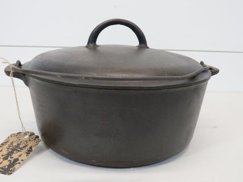 Griswold Large Slant Logo #9 Cast Iron Dutch Oven with: Marked: Erie 834B. Showing some minor pitting beginning. Does sit flush. Handle is bent, as shown in photos. 11" D 