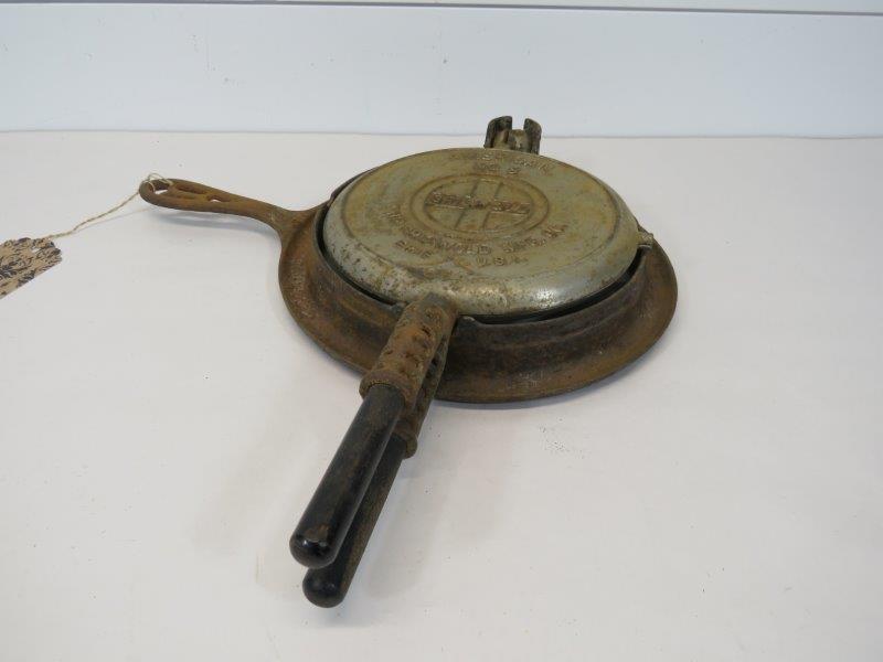 Griswold Slant Logo No. 8/886 Waffle Iron: This waffle iron has wooden handles and does have some rusting, as shown in photos. It does sit flush. 7 1/4" W