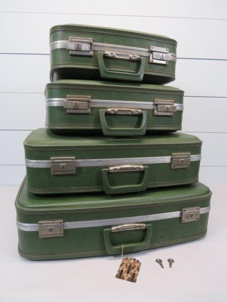 Vintage Green Travel Suitcase Set: A graduated set of four pieces of luggage including the cosmetics case. Overall, very clean. With a few places of internal separation of lining, due to wear and age, as shown in photos. With two keys.